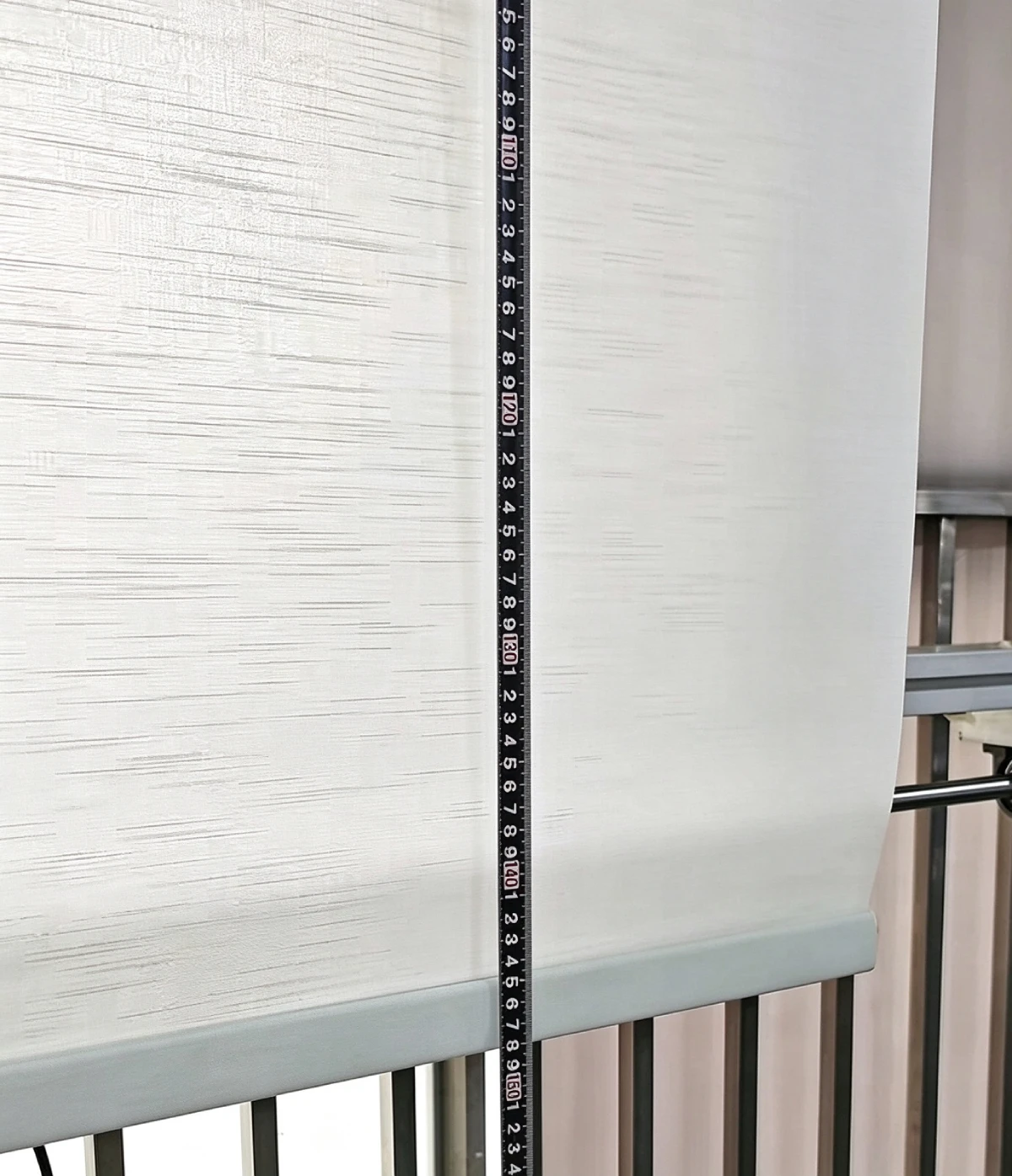 Dimension check of finished roller blinds during quality control at UNITEC